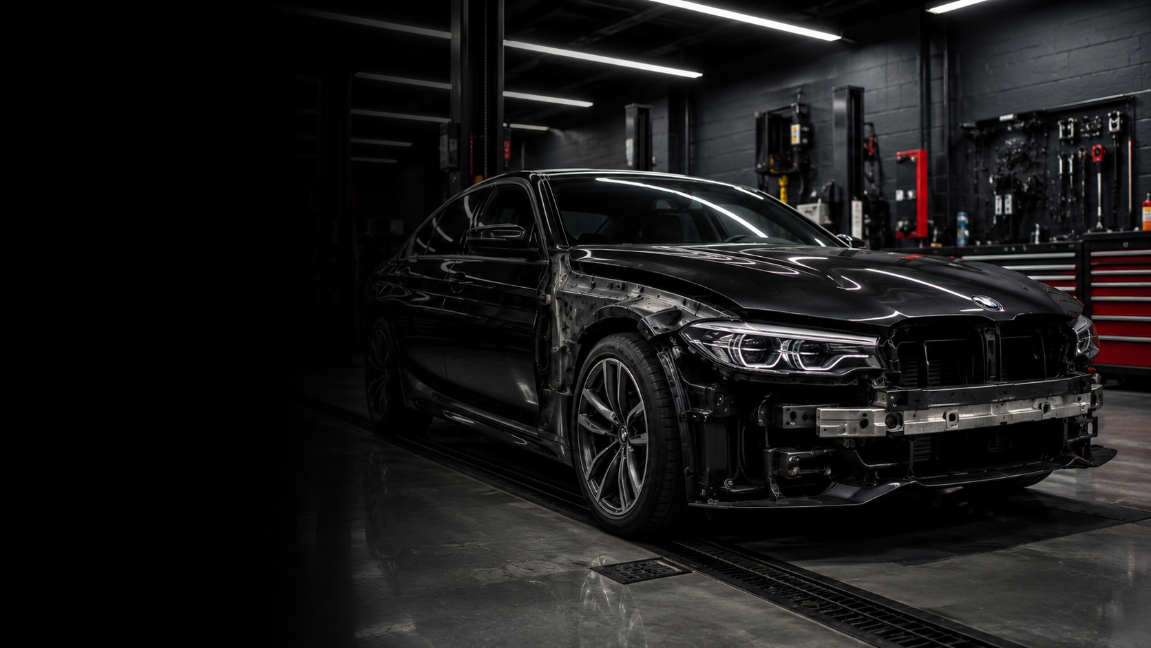 Black luxury sedan undergoing collision repair in a premium Miami facility